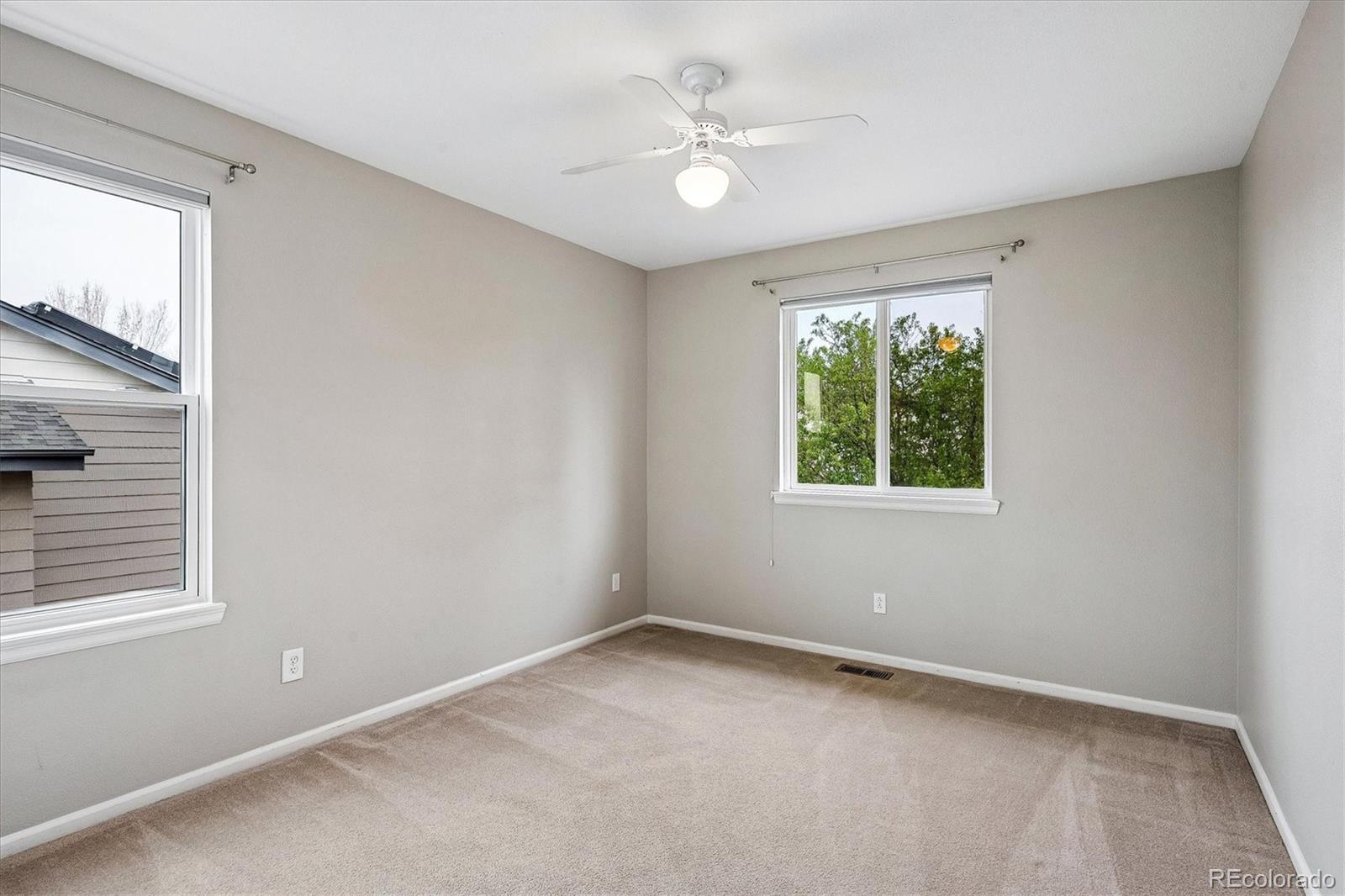 6299 Shannon Trail Highlands Ranch, CO 80130 - Photo 26 of 40 an empty room with a window and a fan