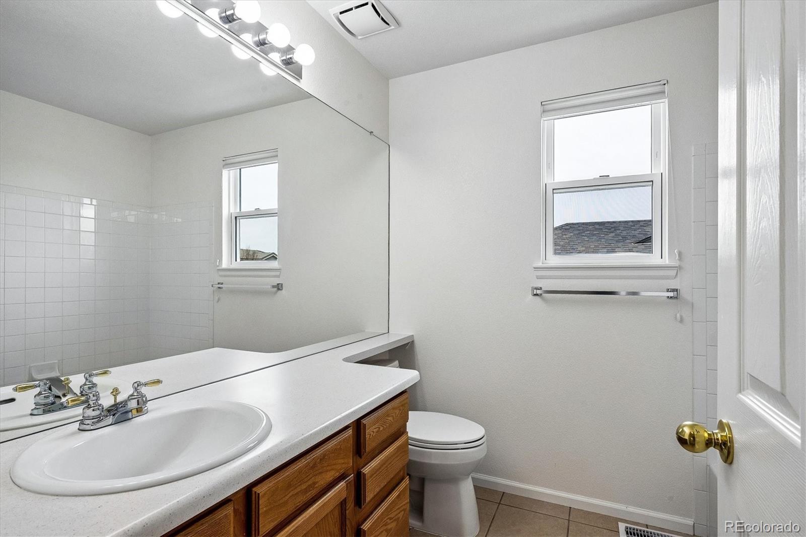 6299 Shannon Trail Highlands Ranch, CO 80130 - Photo 27 of 40 a bathroom with a sink a toilet and a mirror