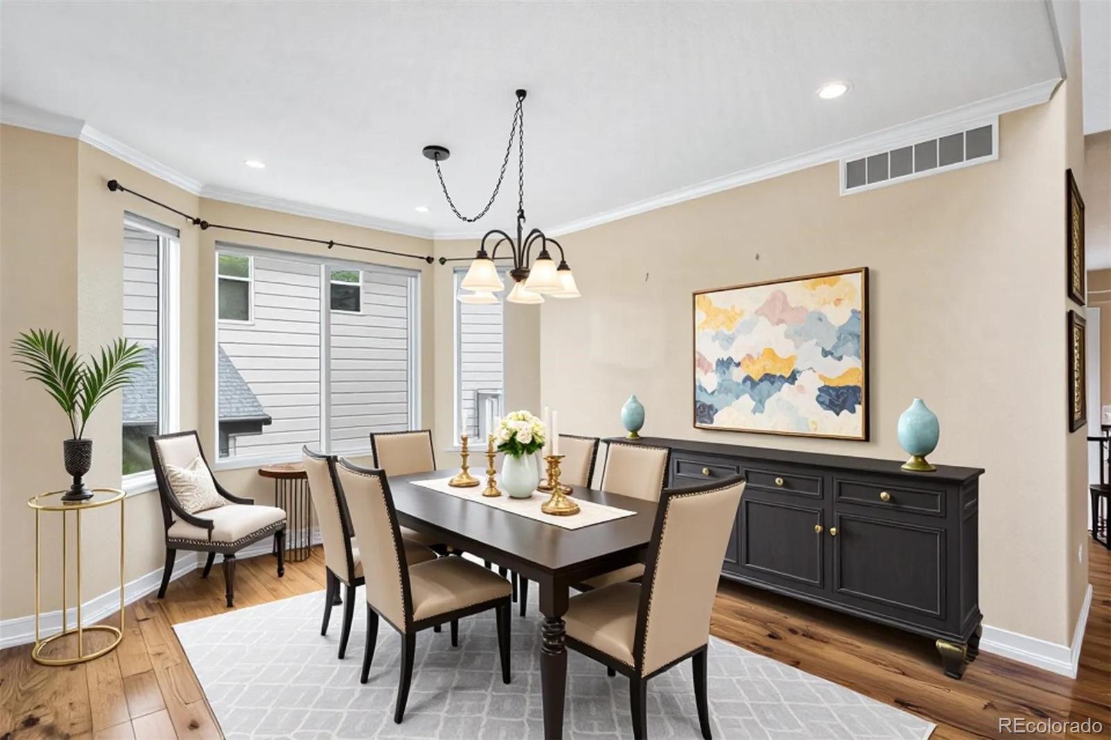 6299 Shannon Trail Highlands Ranch, CO 80130 - Photo 5 of 40 a dining room with wooden floor a chandelier a wooden table and chairs