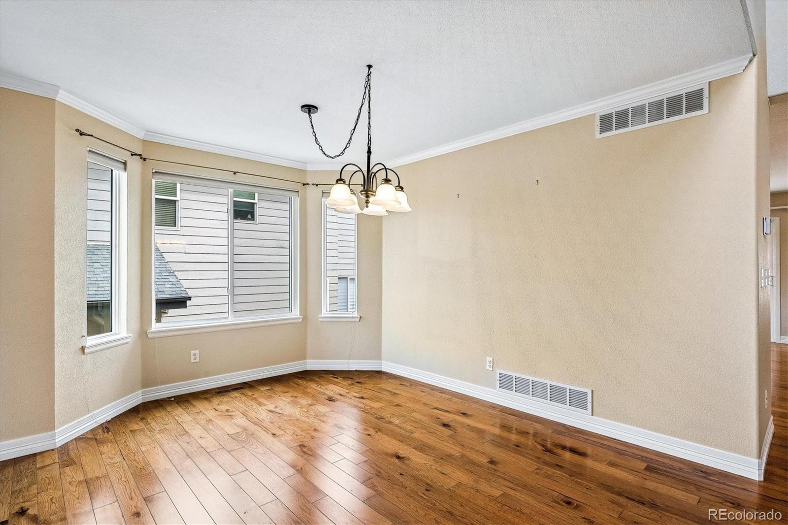 6299 Shannon Trail Highlands Ranch, CO 80130 - Photo 6 of 40 a view of empty room with wooden floor and fan