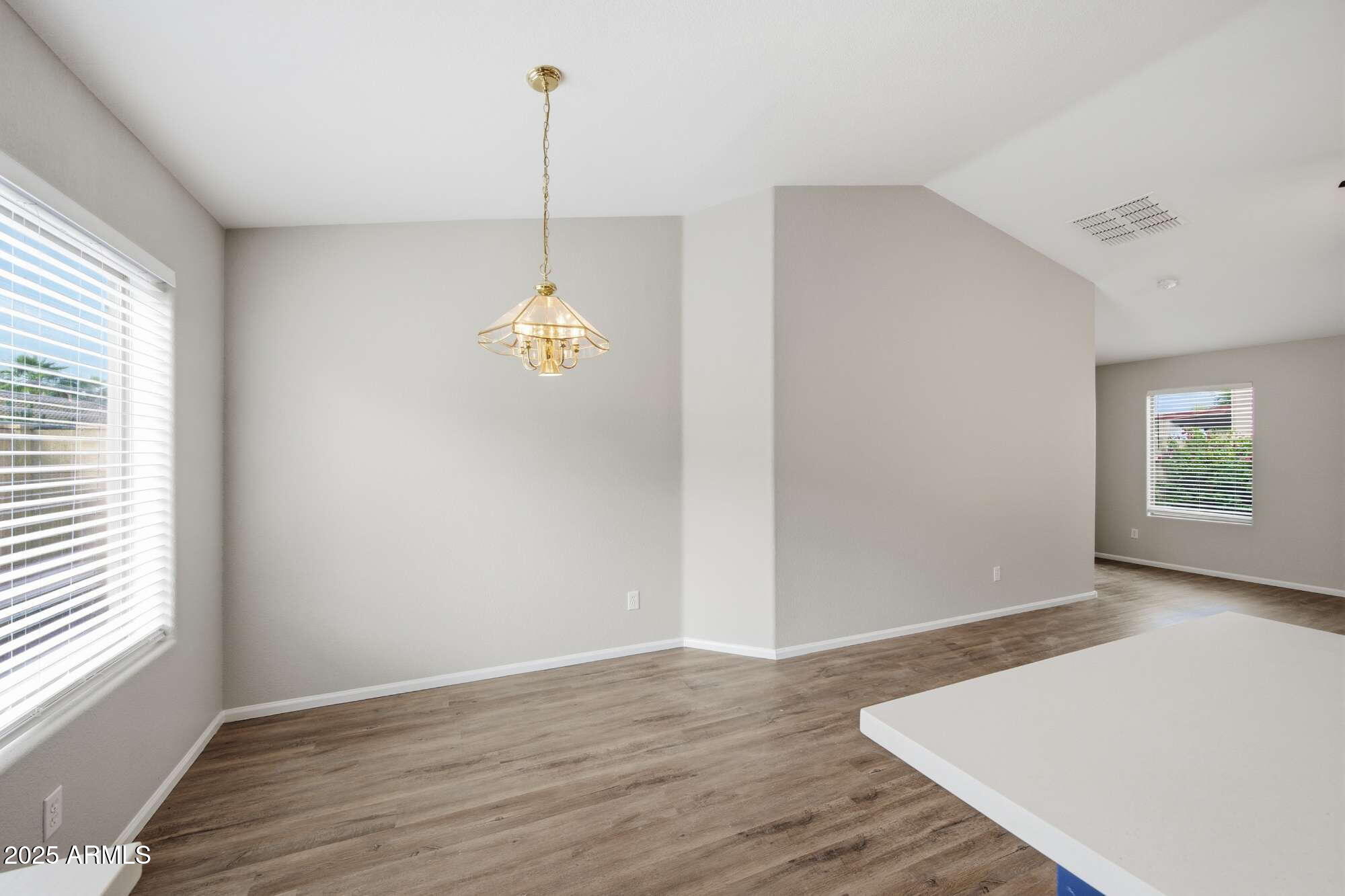 4128 East Copper Road San Tan Valley, AZ 85143 - Photo 12 of 27 a view of an empty room with wooden floor and a window