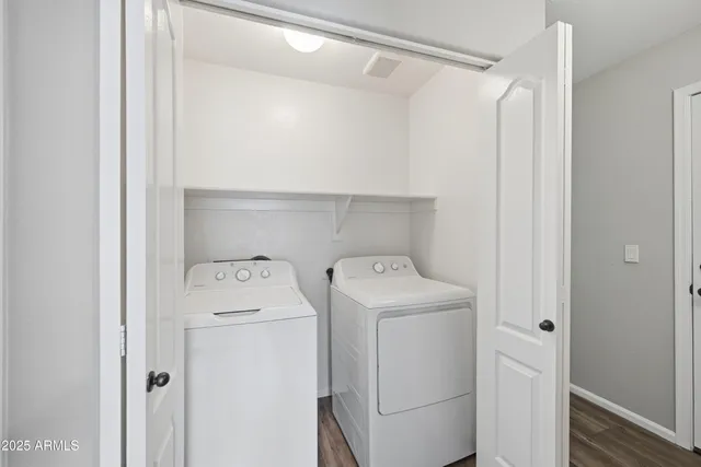 a view of storage and utility room with washer and dryer