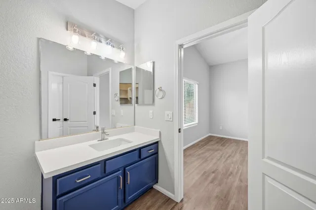 a bathroom with a sink double vanity and a mirror