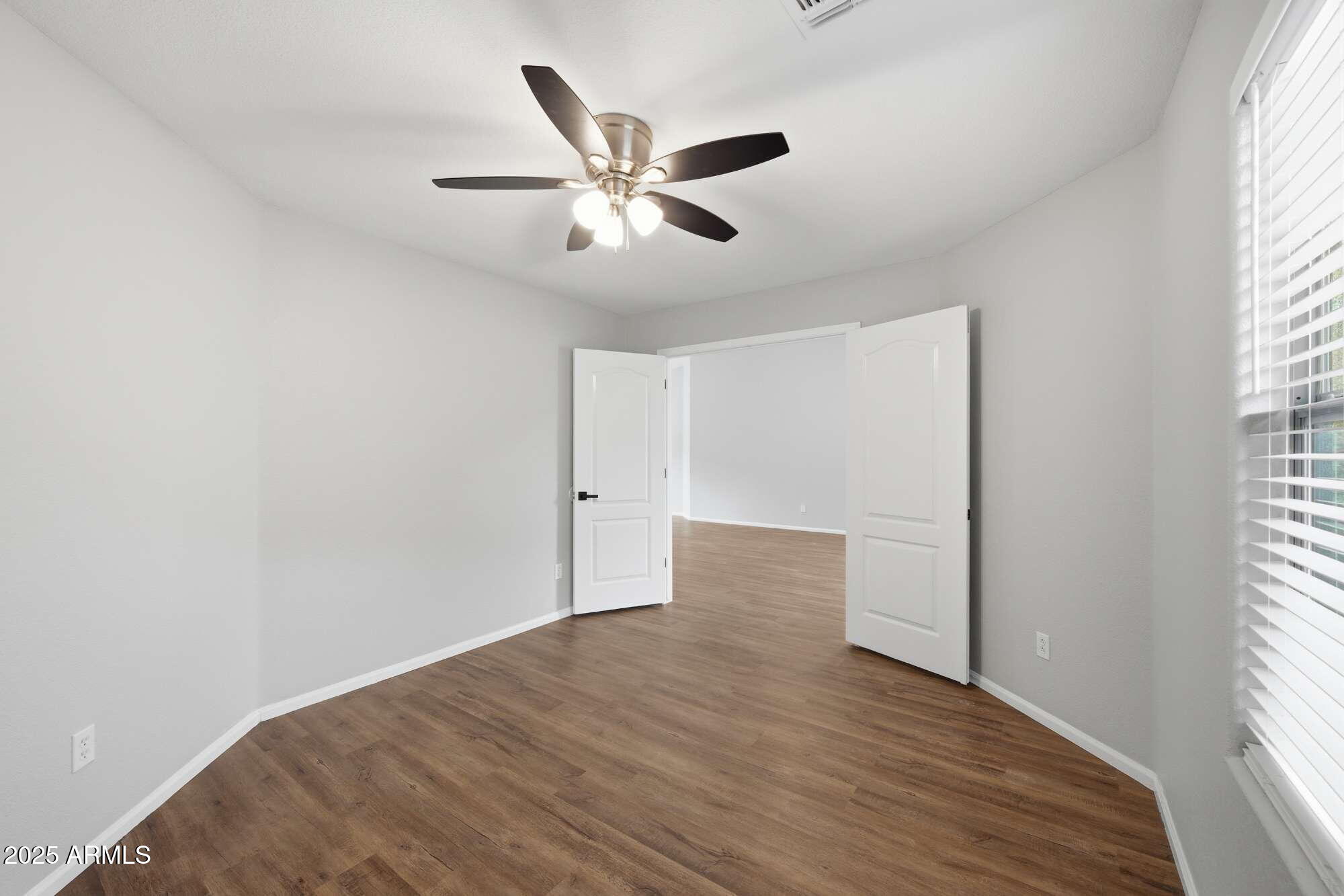4128 East Copper Road San Tan Valley, AZ 85143 - Photo 18 of 27 a view of empty room with wooden floor and fan