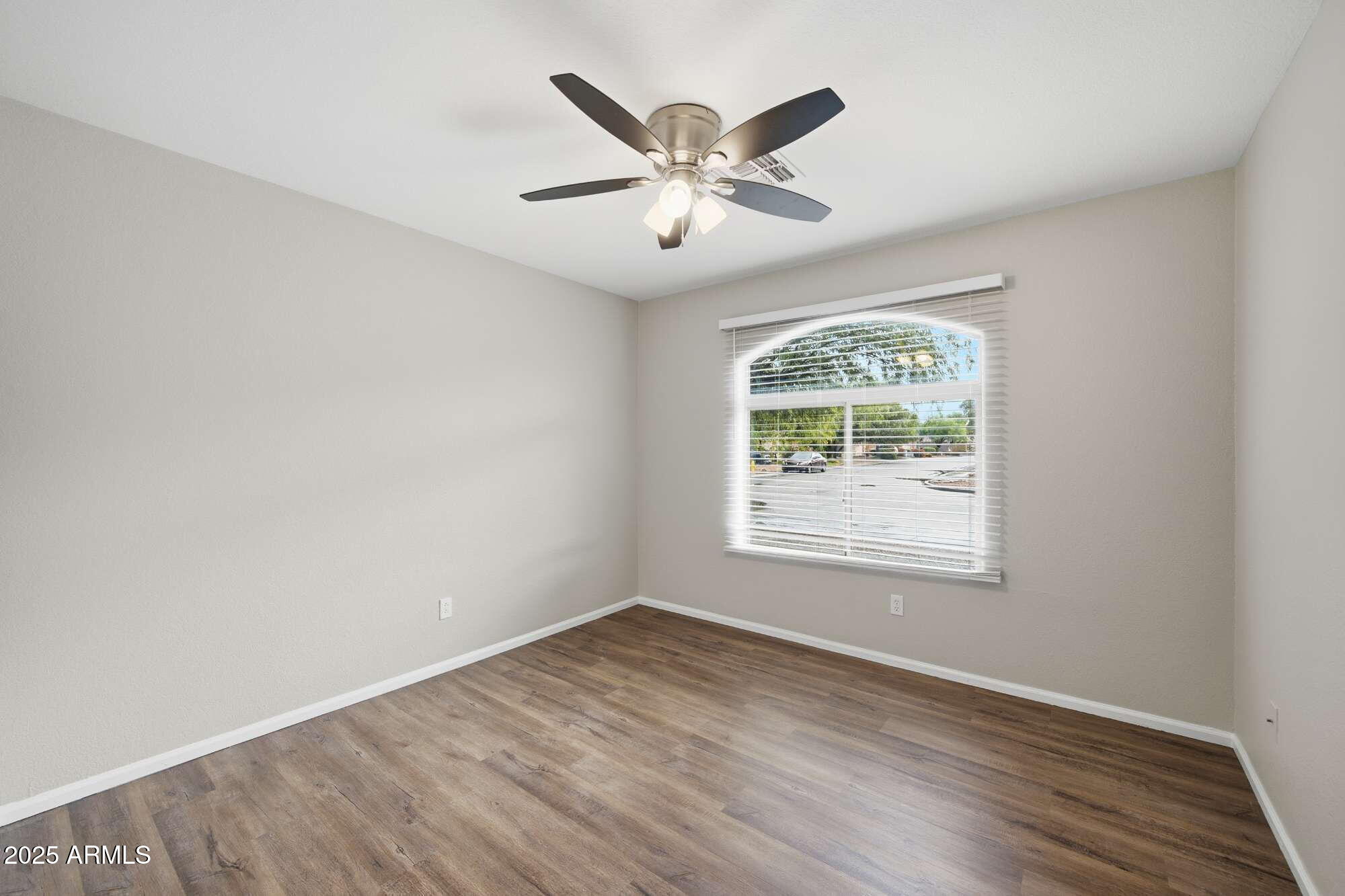 4128 East Copper Road San Tan Valley, AZ 85143 - Photo 20 of 27 an empty room with wooden floor fan and windows