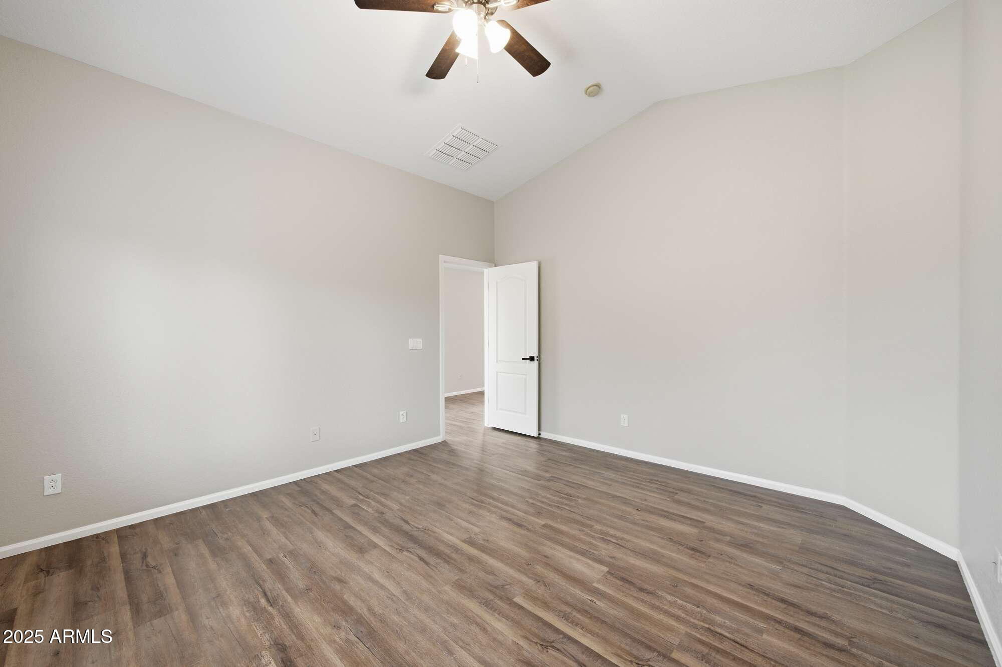 4128 East Copper Road San Tan Valley, AZ 85143 - Photo 5 of 27 a view of an empty room with wooden floor