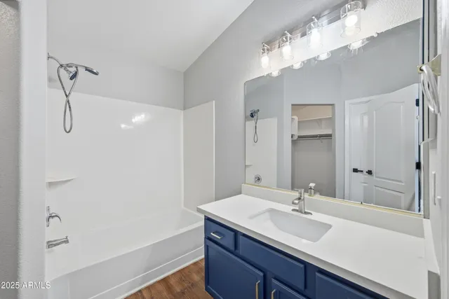 a bathroom with a sink double vanity granite tub and shower