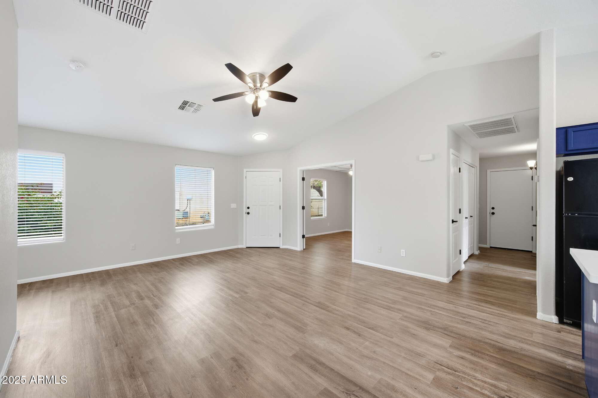 4128 East Copper Road San Tan Valley, AZ 85143 - Photo 7 of 27 a view of an empty room with wooden floor and a window