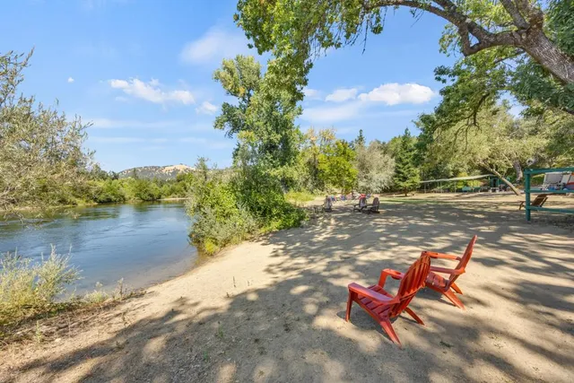 a kitchen with kitchen island a large counter top space a sink stainless steel appliances and cabinets