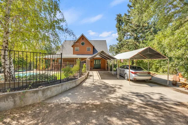 a spacious bedroom with furniture and a large window
