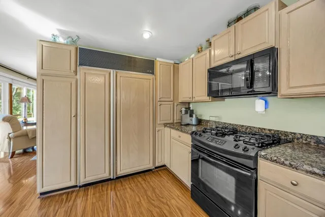 an aerial view of a house with swimming pool garden and patio
