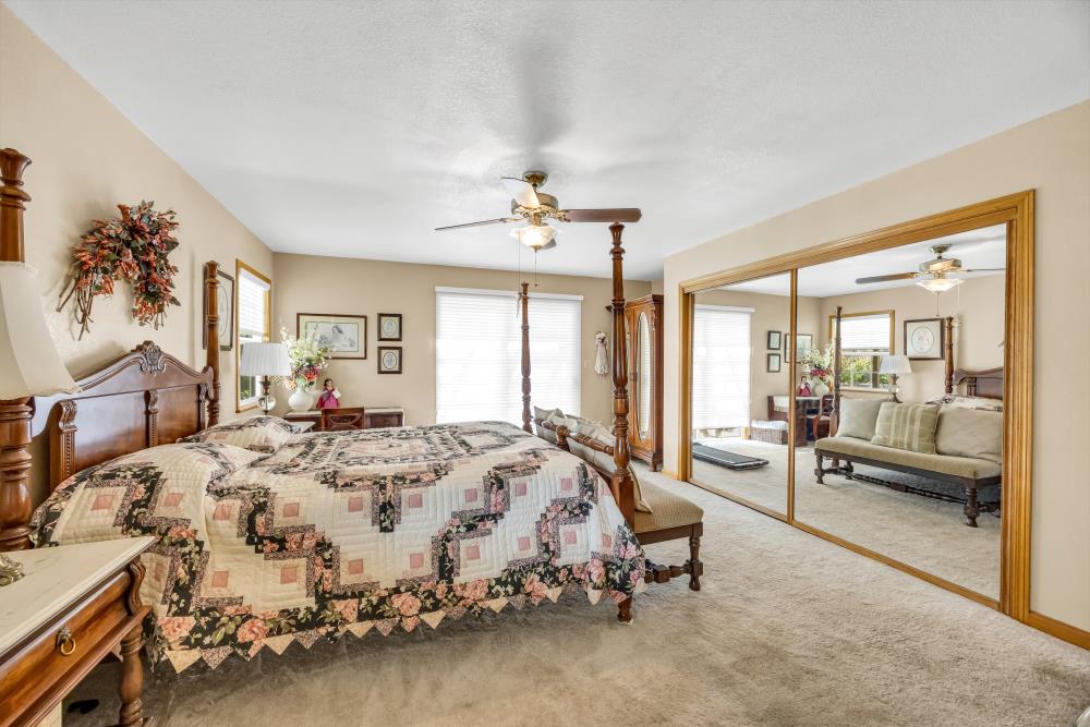 6400 State Highway Lotus, CA 95651 - Photo 36 of 95 a spacious bedroom with a bed couch and a large window with wooden floor