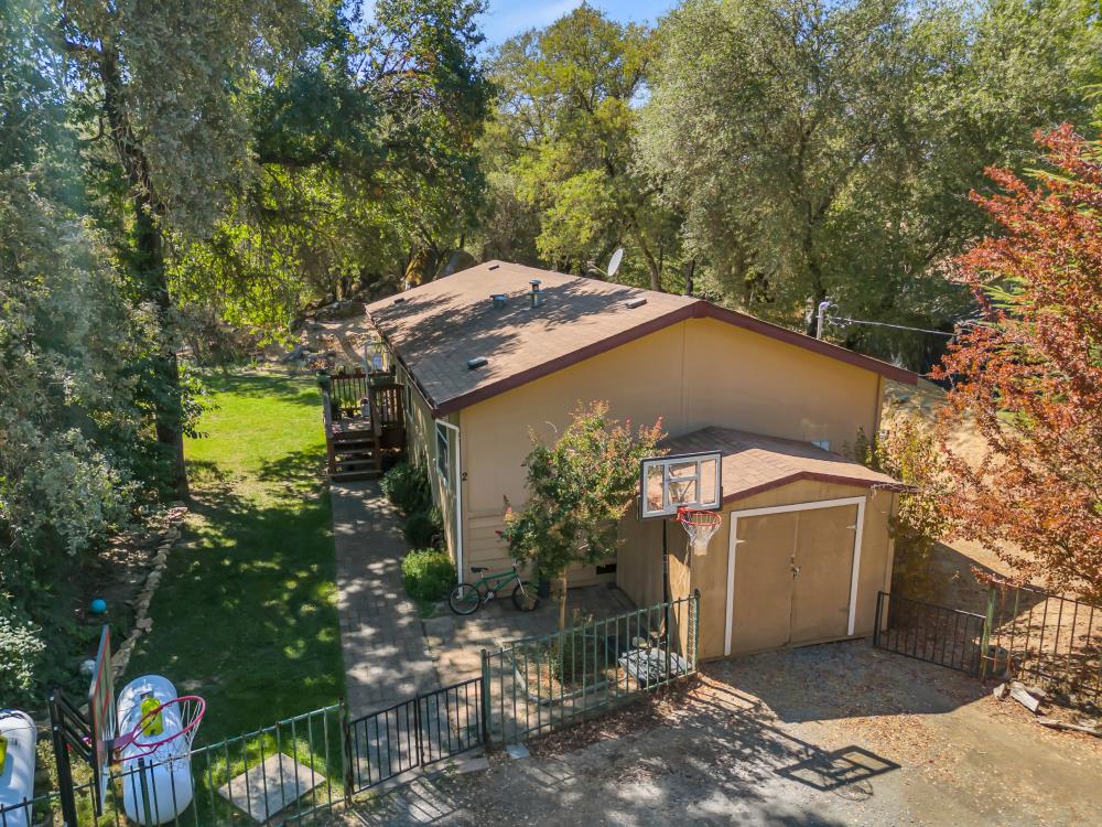 6400 State Highway Lotus, CA 95651 - Photo 60 of 95 a yellow house with trees in front of it