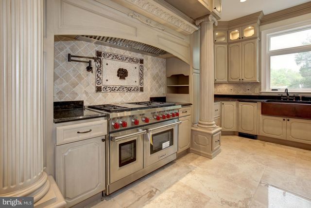 a view of a livingroom with wooden floor and a fireplace
