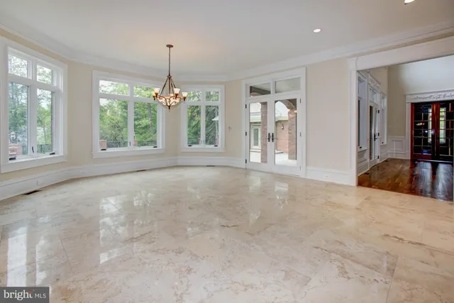 wooden floor fireplace and windows in an empty room