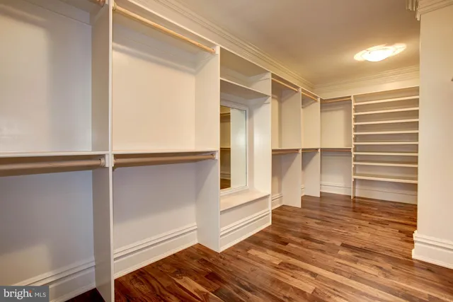 a bathroom with a sink a toilet a mirror and shower