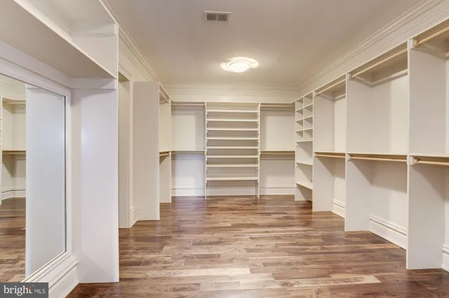 a kitchen with stainless steel appliances granite countertop a sink a stove and a wooden floors