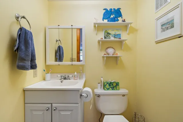 a bathroom with a sink mirror and toilet