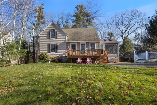 a front view of a house with a yard and trees