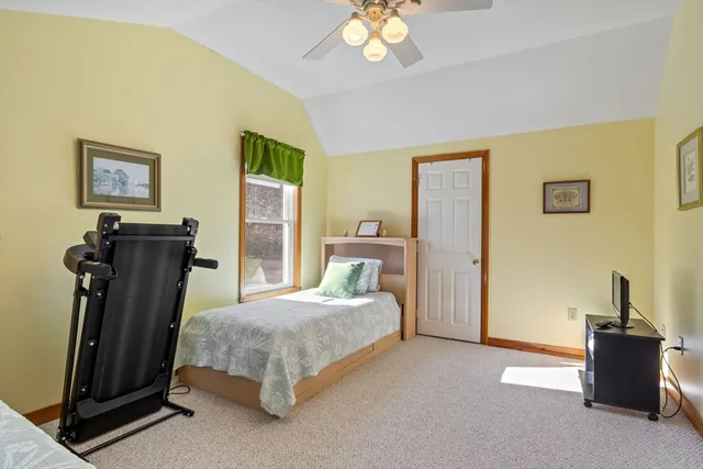 a bedroom with a bed and a painting on the wall