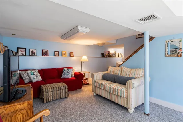 a bedroom with a large bed and a painting on the wall