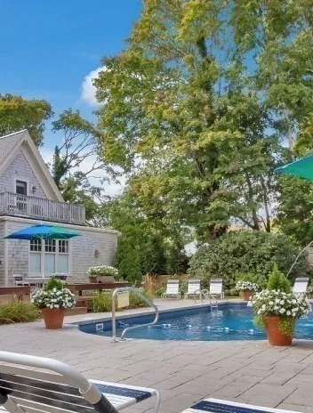 a view of backyard with outdoor seating and plants