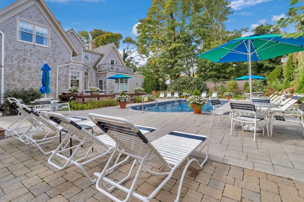 116 Parallel Street Harwich, MA 02645 - Photo 10 of 21 a view of patio with chairs and table under an umbrella