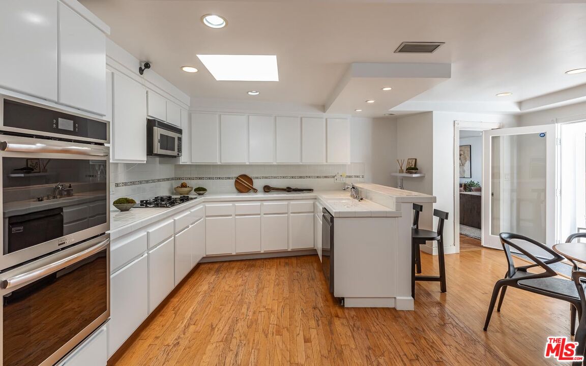 1501 Rising Glen Road Los Angeles, CA 90069 - Photo 4 of 17 a kitchen with a sink stainless steel appliances and cabinets