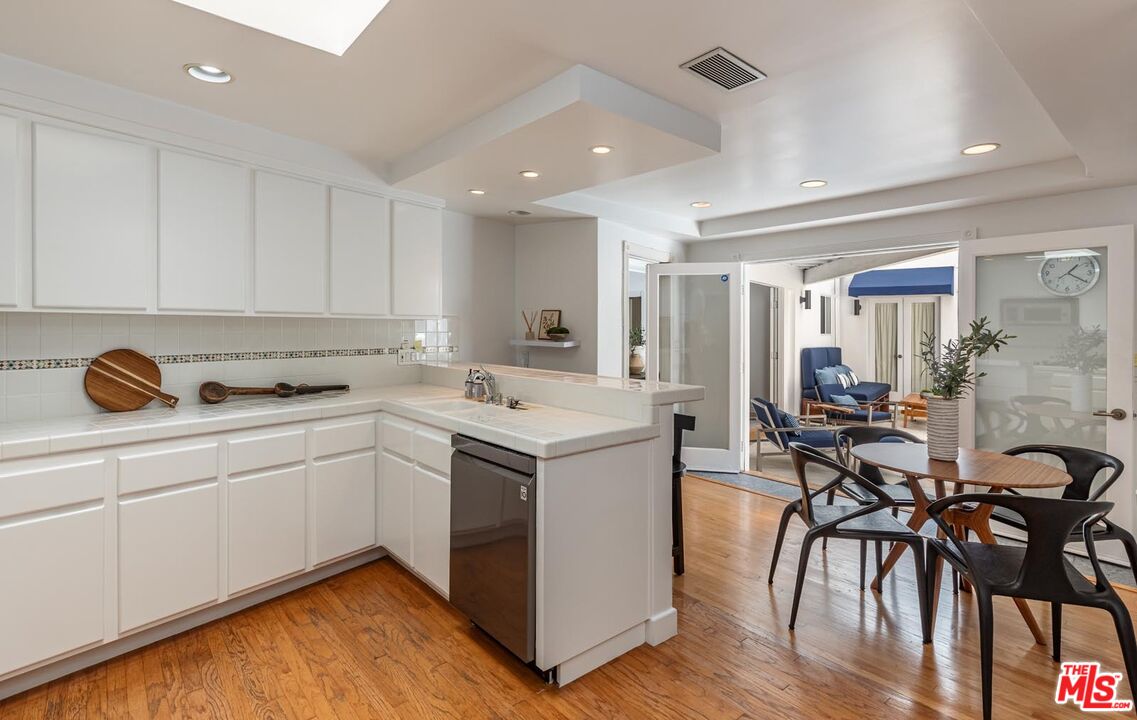 1501 Rising Glen Road Los Angeles, CA 90069 - Photo 5 of 17 a kitchen with a sink a stove and cabinets