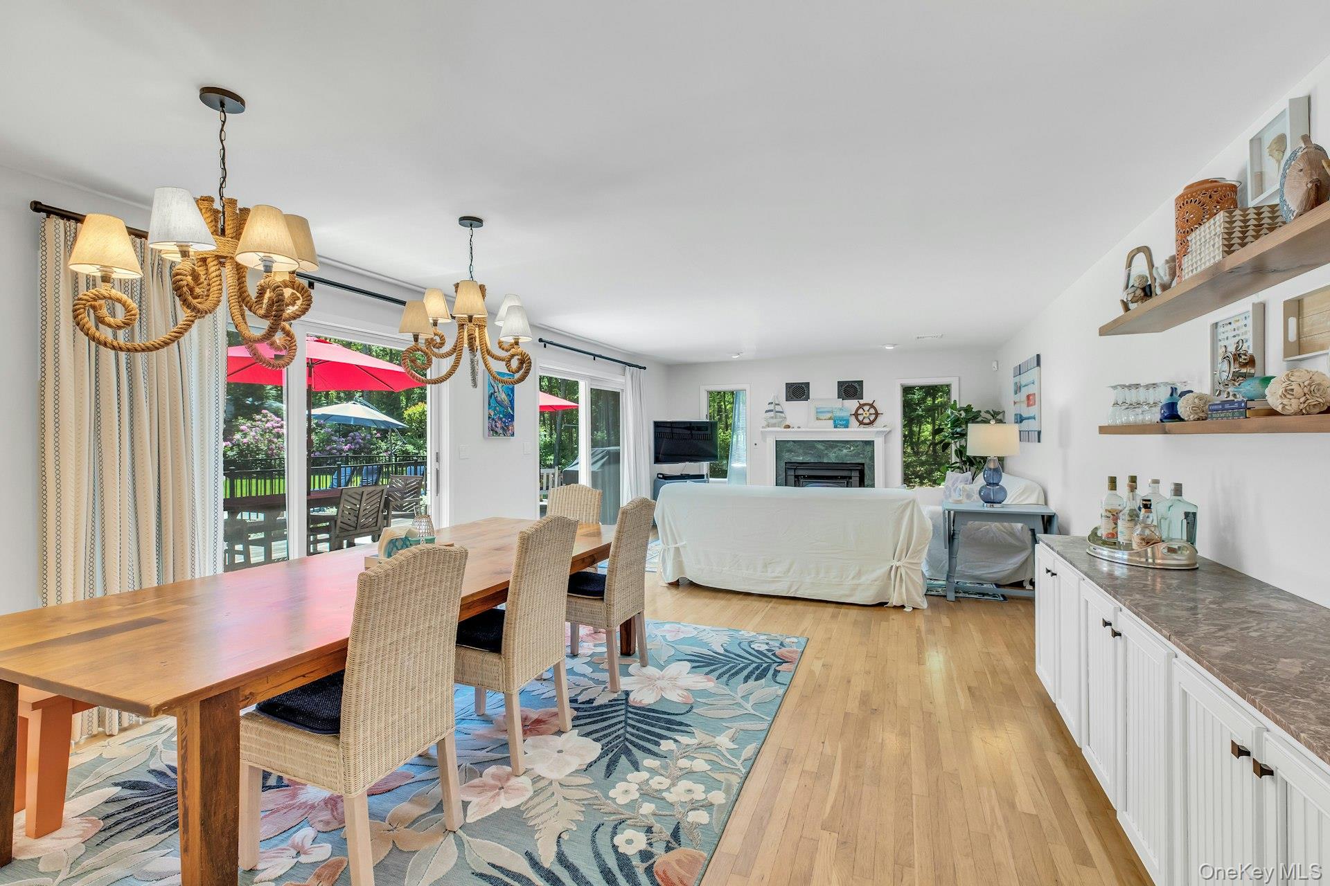 16 Hildreth Road Hampton Bays, NY 11946 - Photo 12 of 29 a view of a dining room and livingroom with furniture wooden floor a chandelier