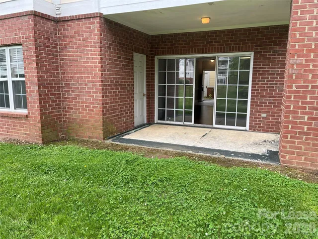a swimming pool with outdoor seating and yard