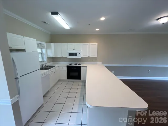 a kitchen with a sink a stove and cabinets