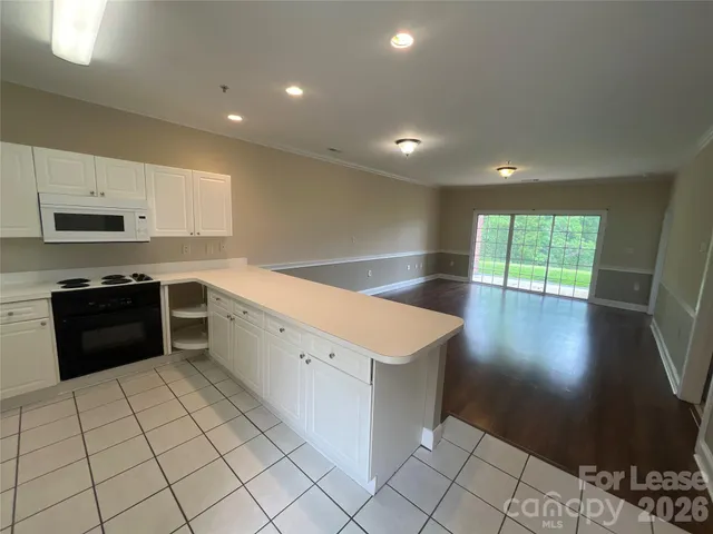 a kitchen with a stove a sink and a refrigerator