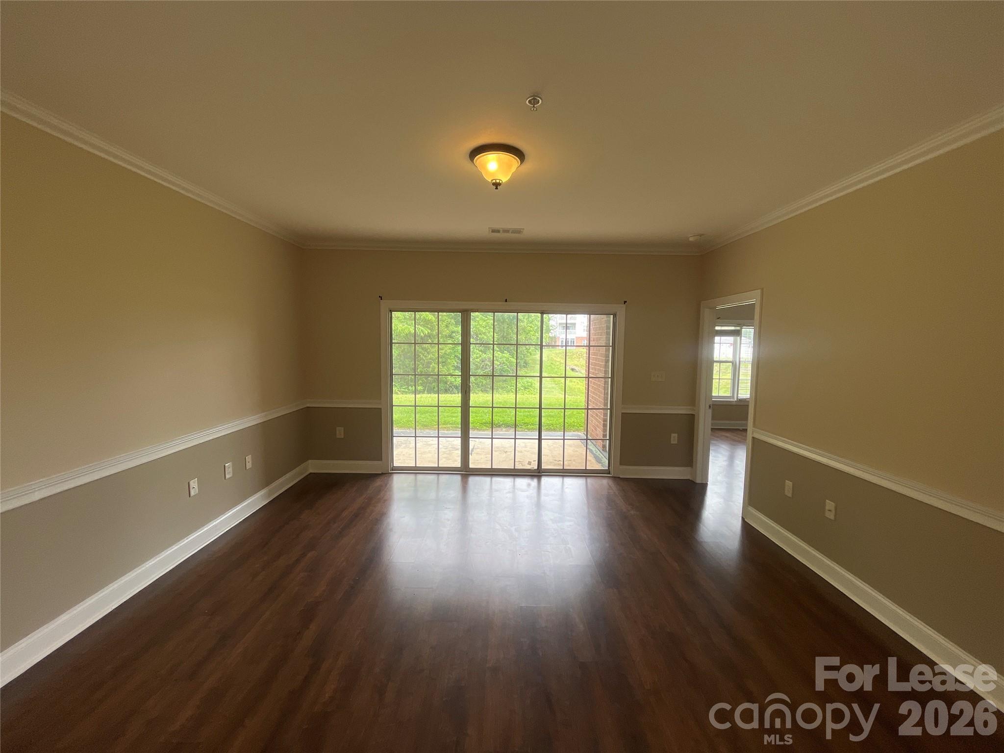 8913 Meadow Vista Road Charlotte, NC 28213 - Photo 6 of 17 a view of an empty room with wooden floor and a window
