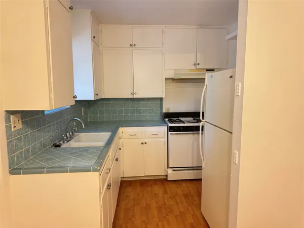 a kitchen with a sink and a refrigerator