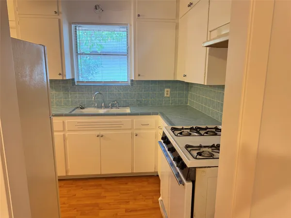 a kitchen with a stove and a refrigerator