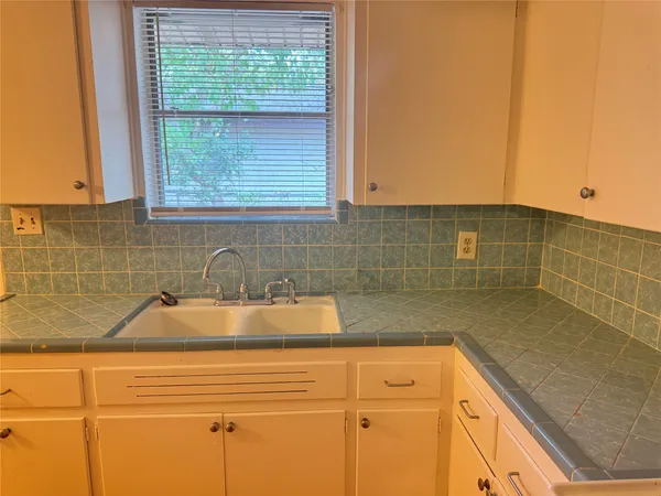 a bathroom with a sink and a window