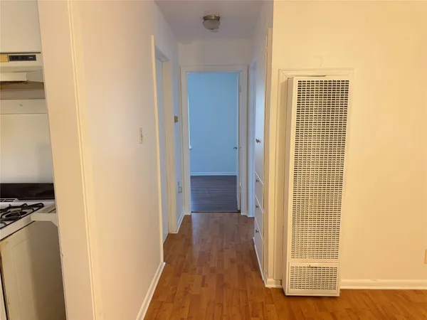 a view of a hallway with wooden floor