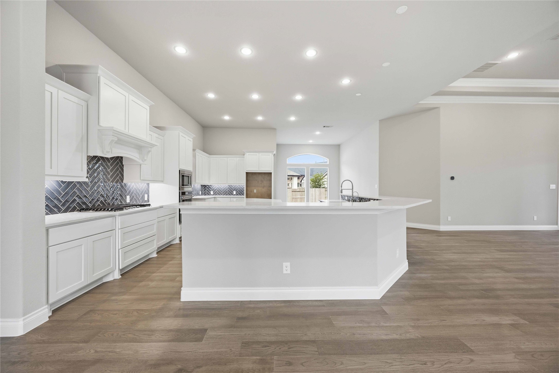 17564 Watercolor Way Conroe, TX 77302 - Photo 13 of 42 Chef's kitchen with quartz counter tops, stylish backsplash, expansive island, stainless steel appliances and walk in pantry