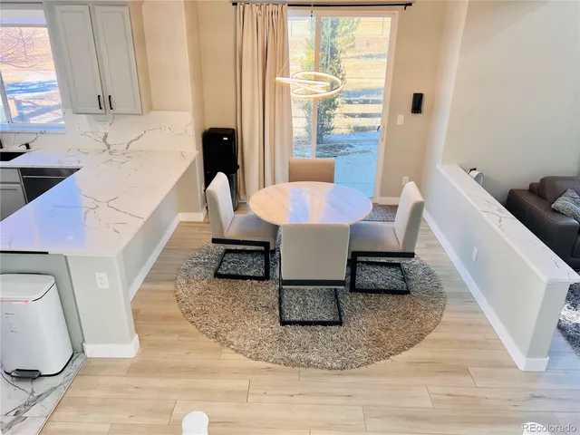 a kitchen with white cabinets and sink