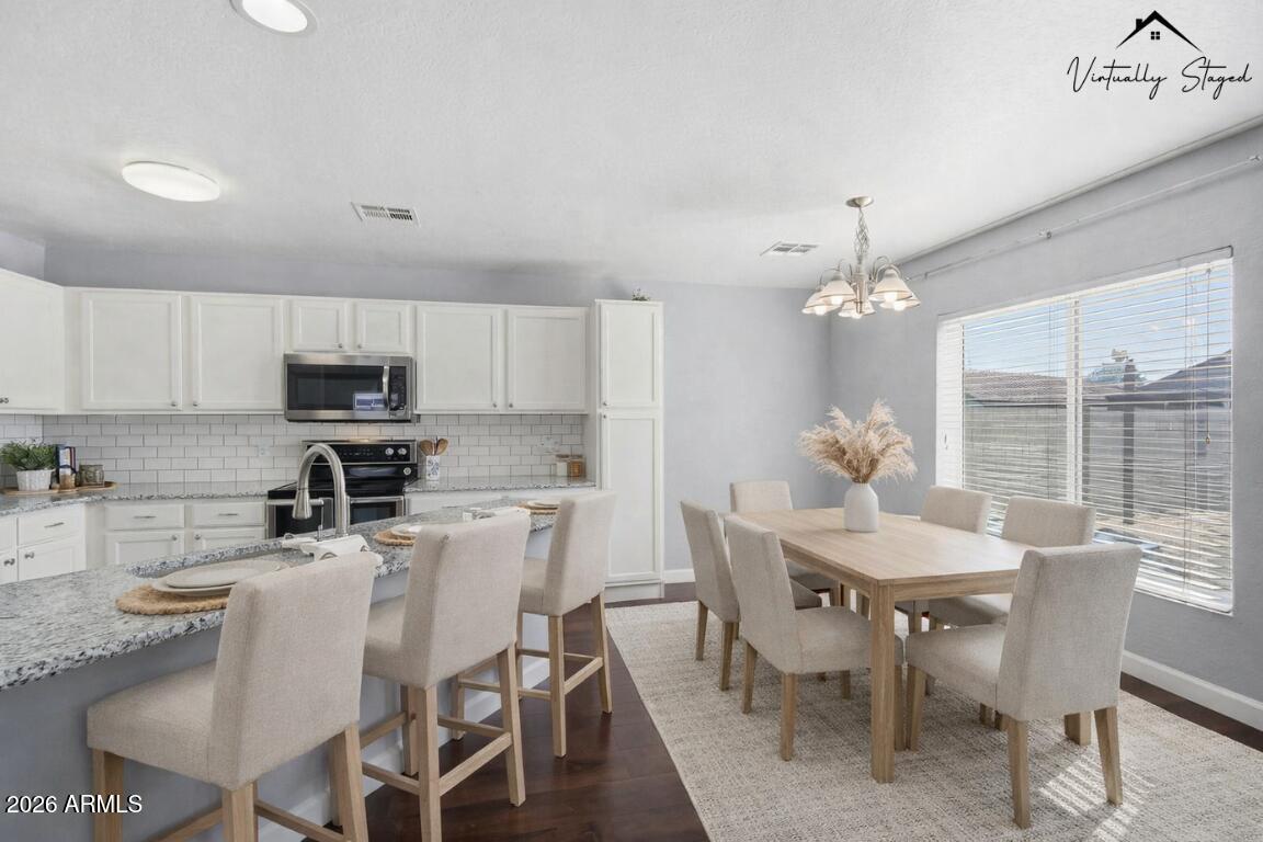 1707 West Harding Avenue Coolidge, AZ 85128 - Photo 11 of 53 a view of a dining room with furniture a chandelier and kitchen view