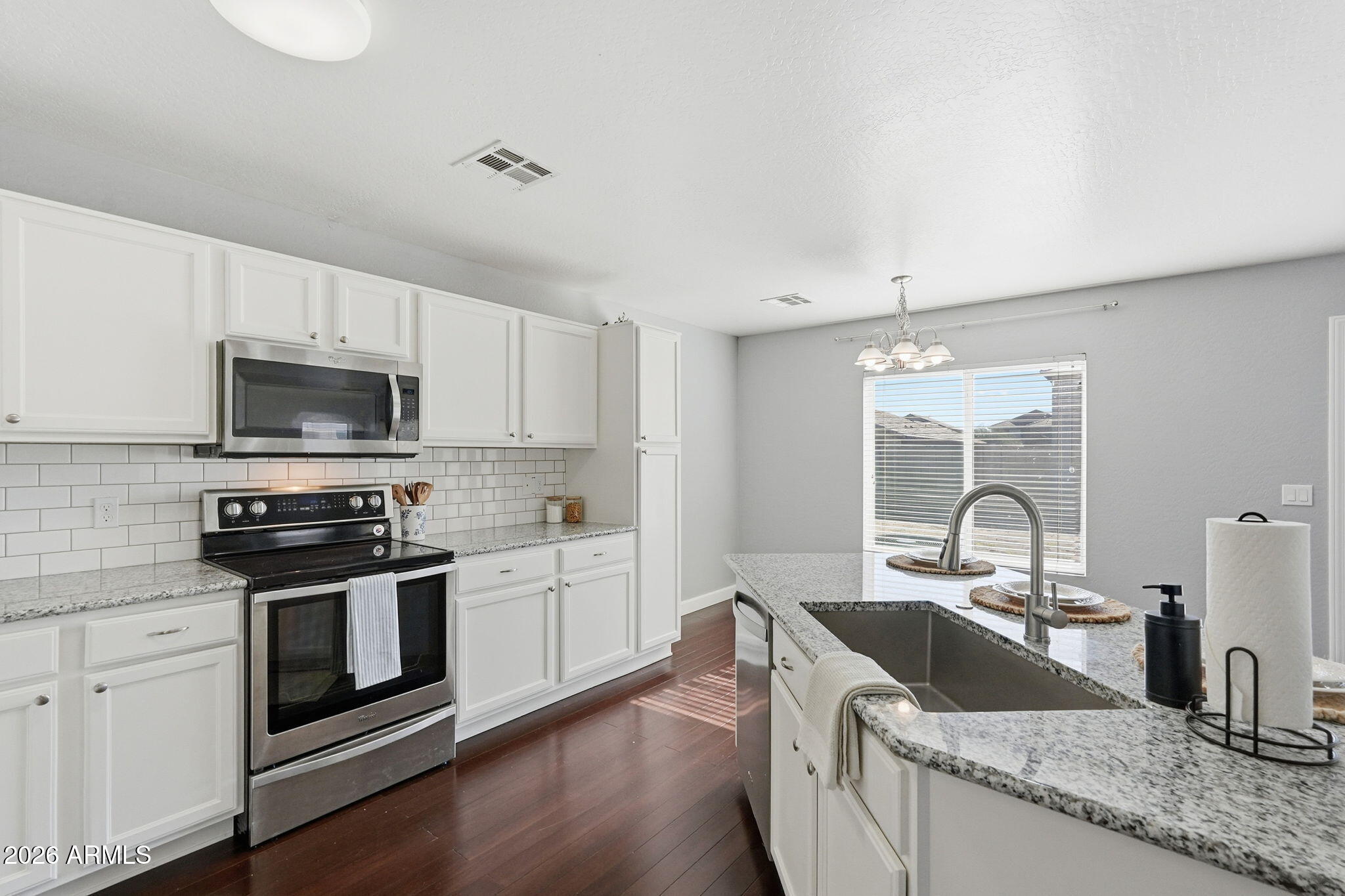 1707 West Harding Avenue Coolidge, AZ 85128 - Photo 17 of 53 a kitchen with granite countertop a stove sink and microwave