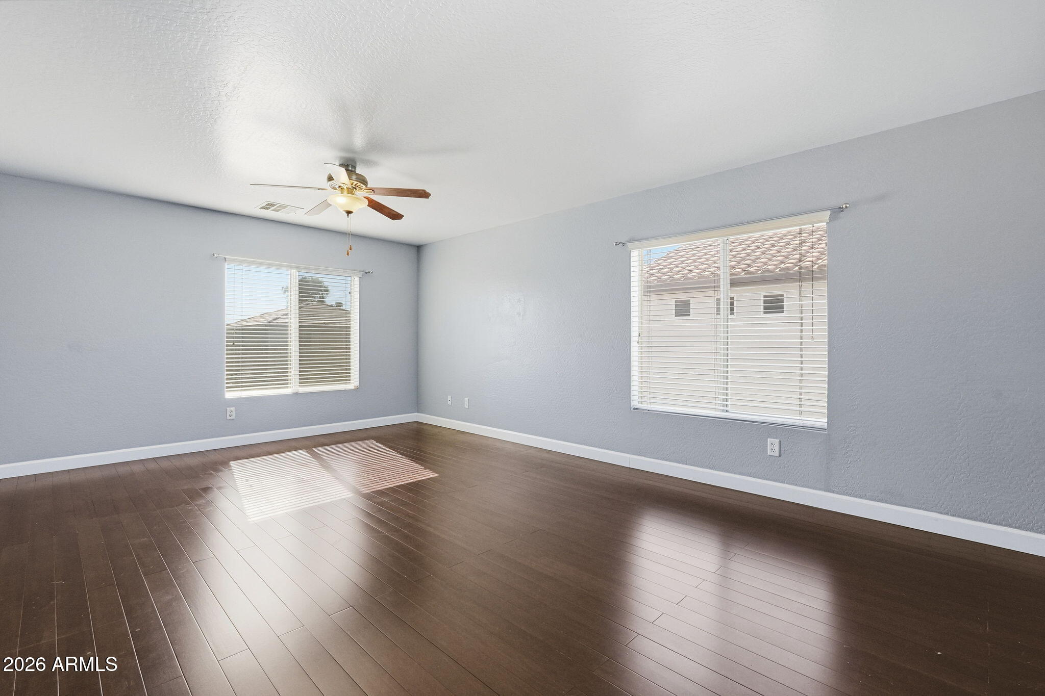 1707 West Harding Avenue Coolidge, AZ 85128 - Photo 24 of 53 a view of an empty room with wooden floor and a window