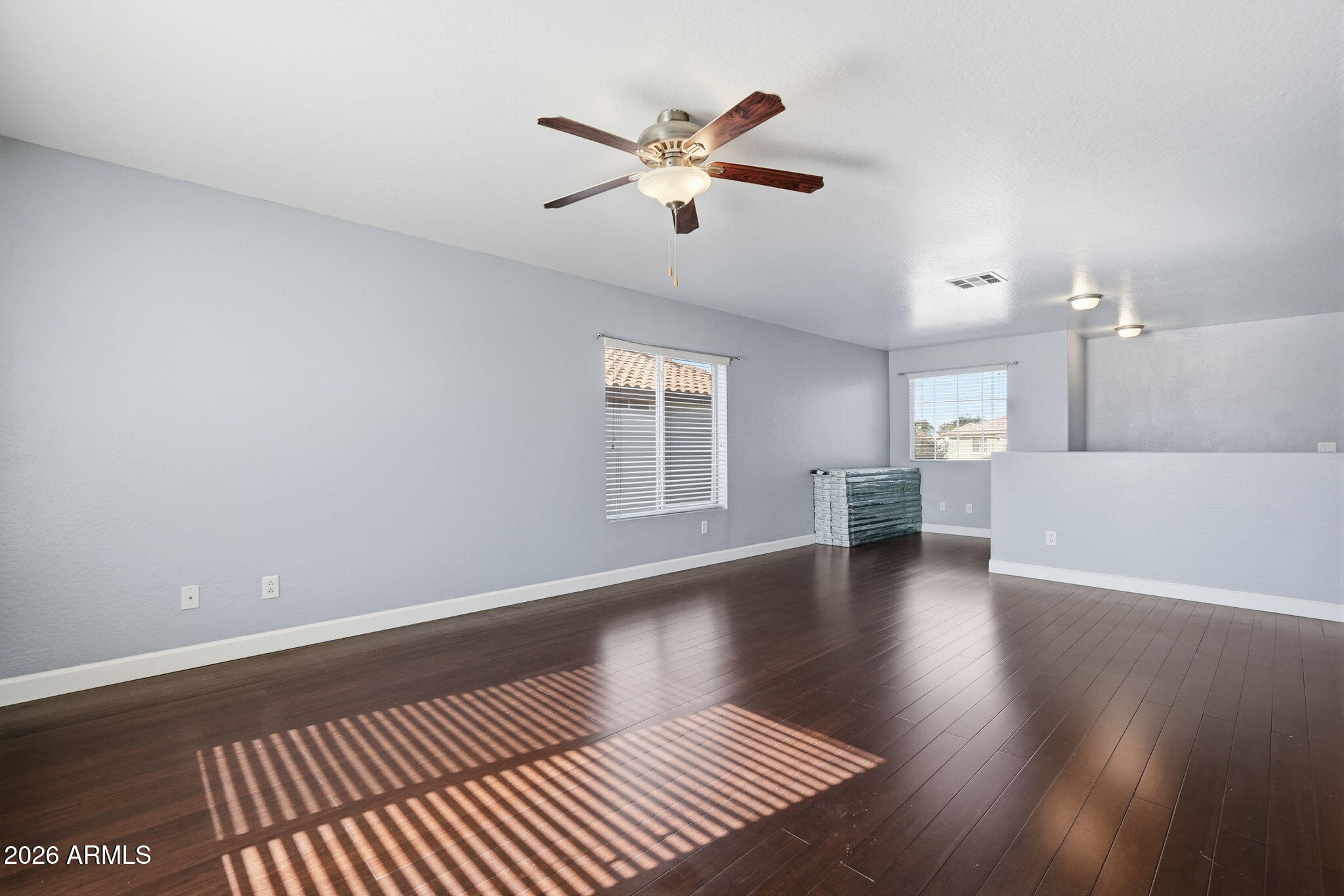 1707 West Harding Avenue Coolidge, AZ 85128 - Photo 25 of 53 a view of an empty room with wooden floor and a ceiling fan