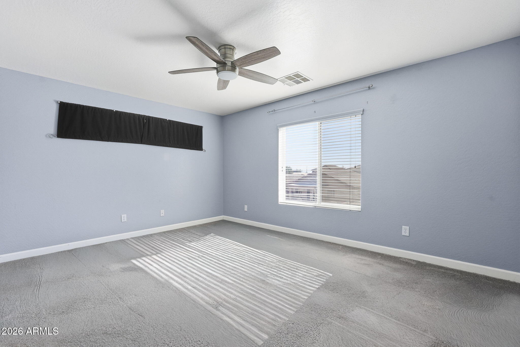 1707 West Harding Avenue Coolidge, AZ 85128 - Photo 28 of 53 en empty room with windows and ceiling fan