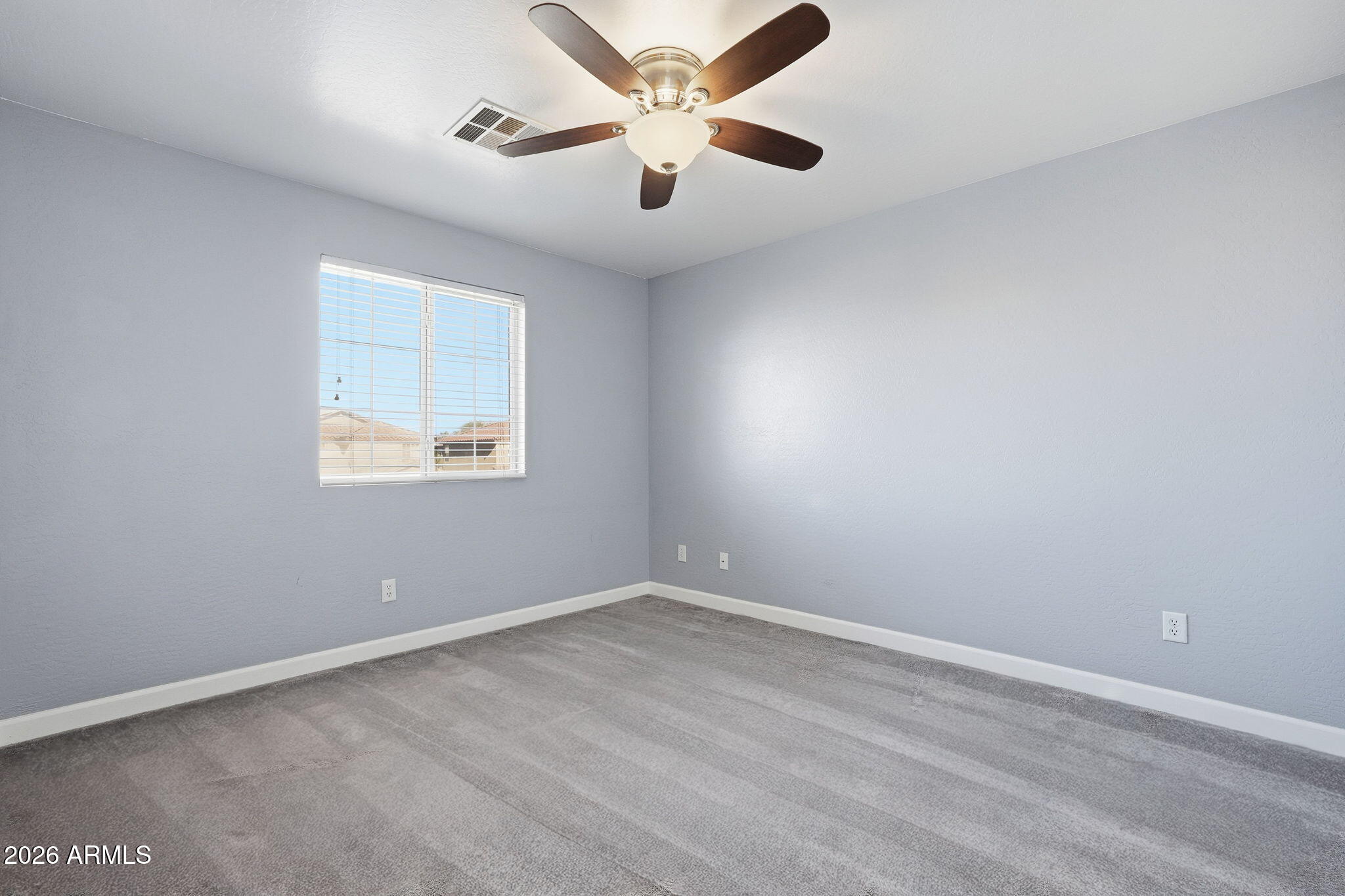 1707 West Harding Avenue Coolidge, AZ 85128 - Photo 36 of 53 an empty room with a window and a fan