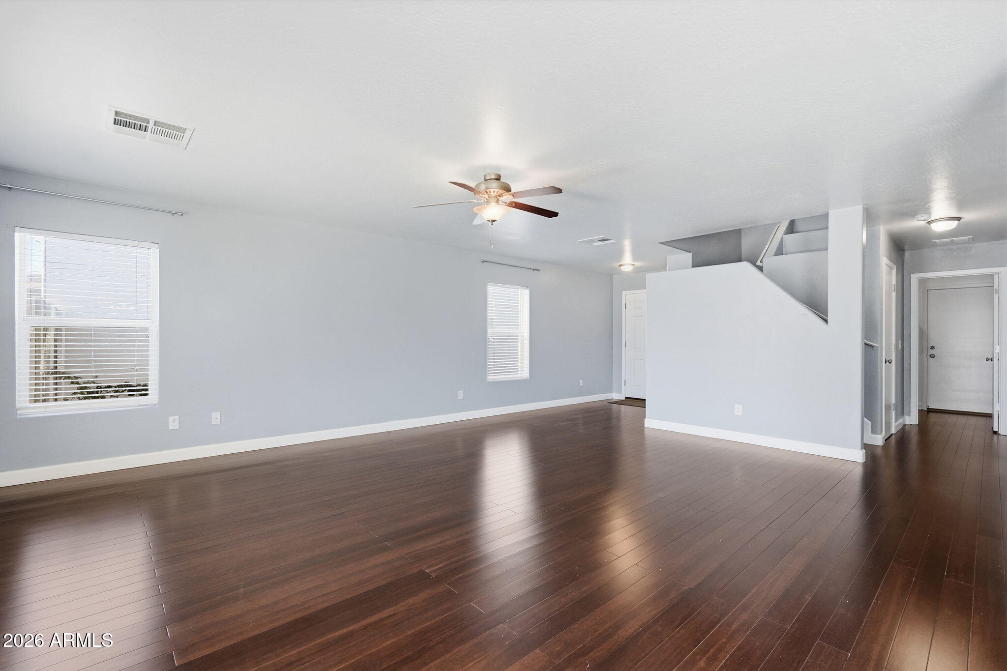 1707 West Harding Avenue Coolidge, AZ 85128 - Photo 9 of 53 a view of an empty room with wooden floor and a window