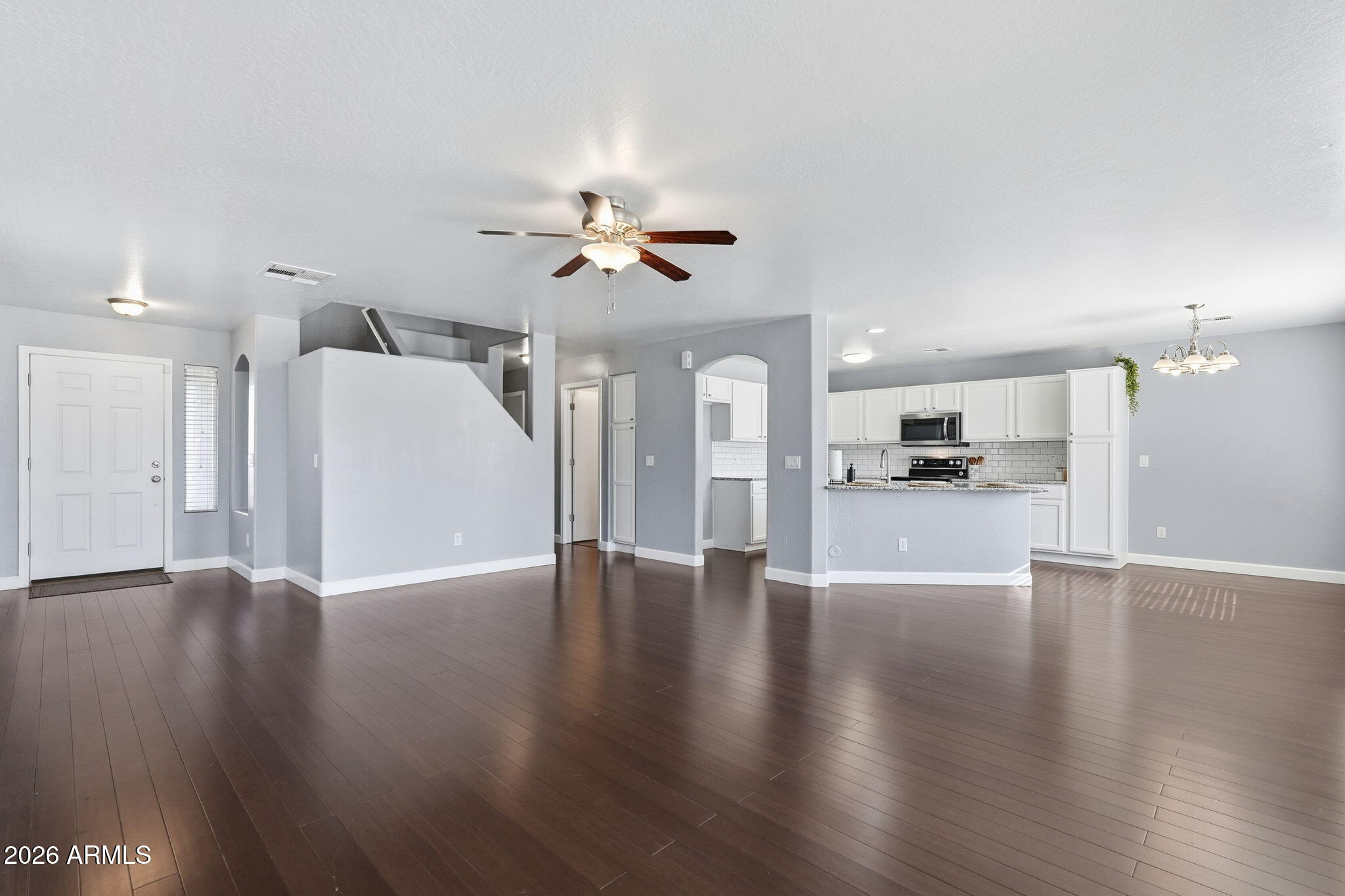 1707 West Harding Avenue Coolidge, AZ 85128 - Photo 10 of 53 a view of an empty room with wooden floor and a kitchen