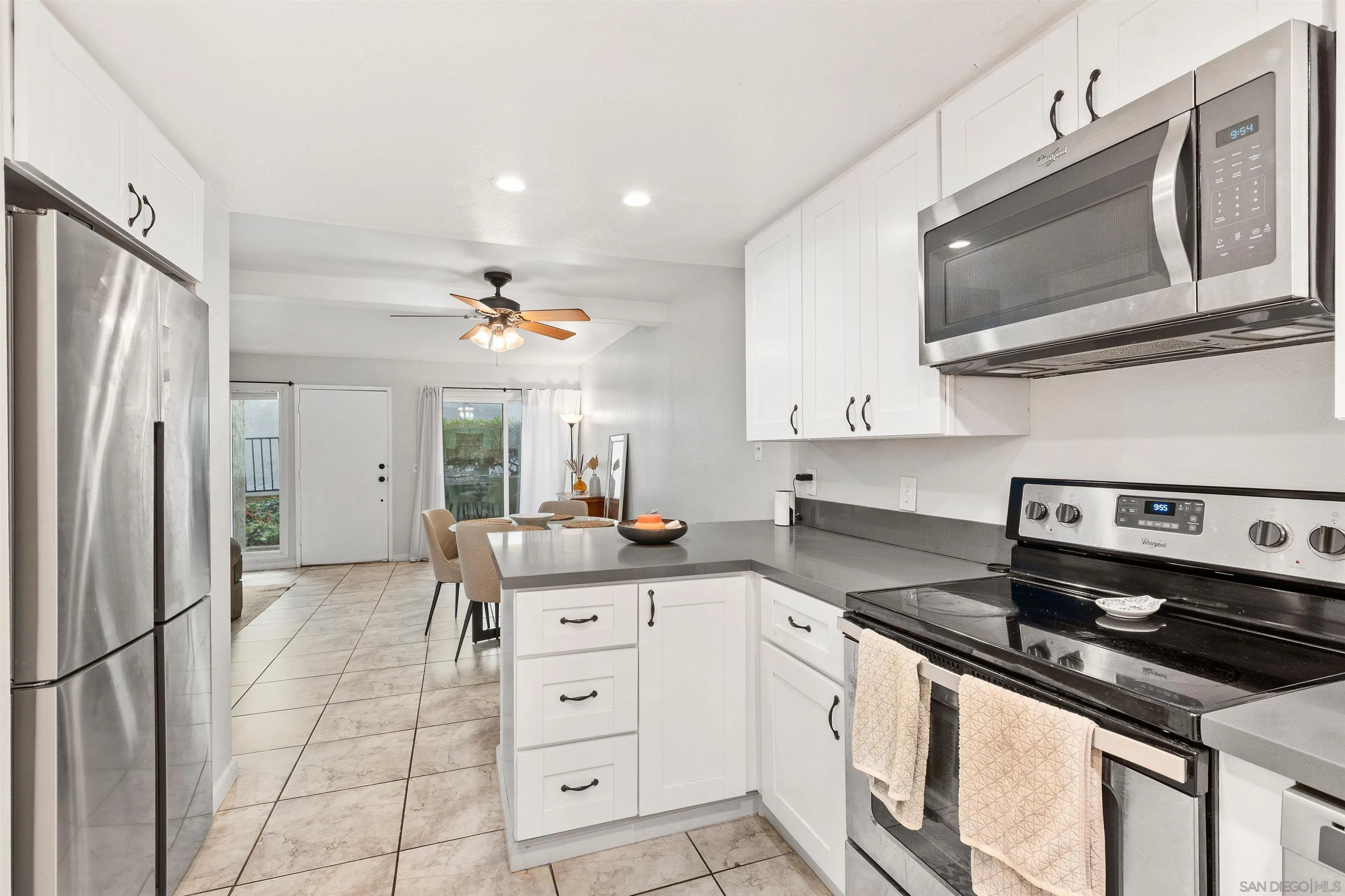 8366 Via Sonoma, Unit D La Jolla, CA 92037 - Photo 9 of 43 a kitchen with stainless steel appliances a stove microwave and a refrigerator