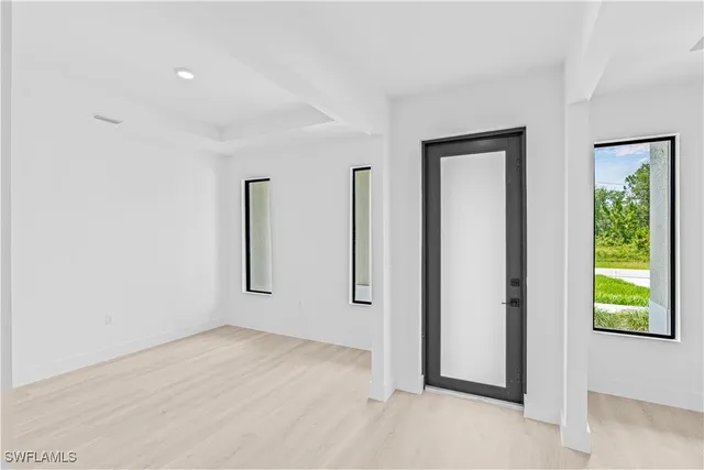 an empty room with windows and closet